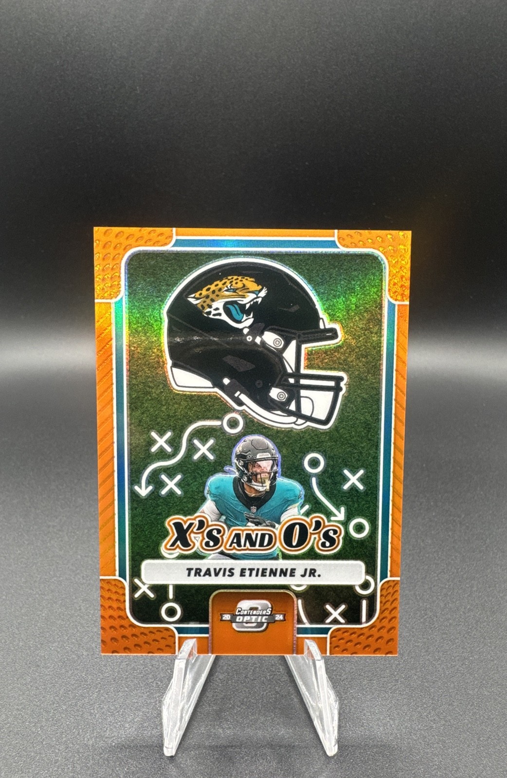 2024 Panini Contenders Optic – XS and Os Travis Etienne #XO-TEJ Orange Prizm /50