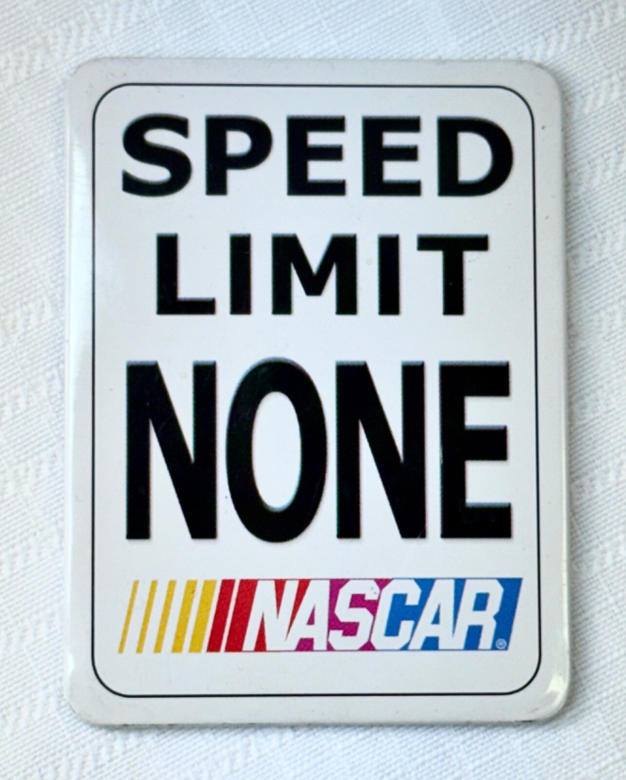Vintage 3-1/8″ x 2-3/8″ “SPEED LIMIT NONE” NASCAR Tin/Metal Magnet