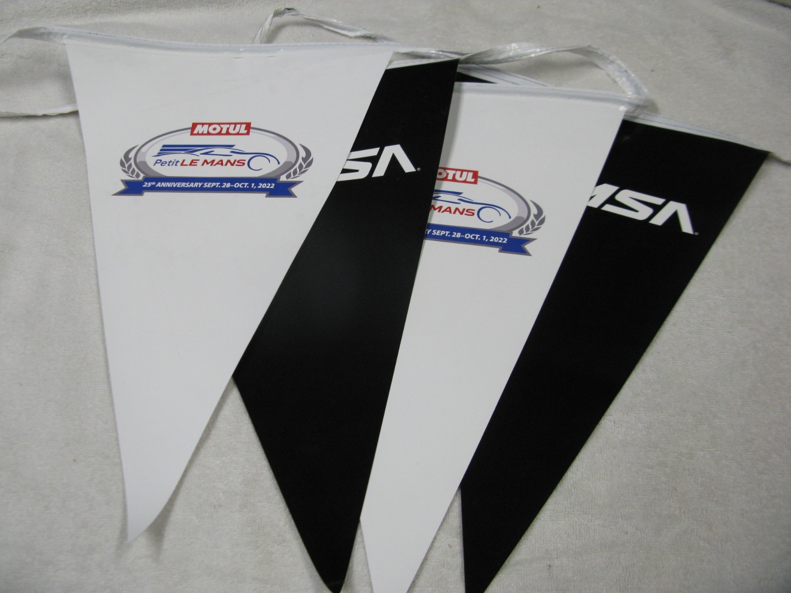IMSA – MOTUL Petit LE MANS Triangle Banner 6ft – 6in long, and 16.5in tall.