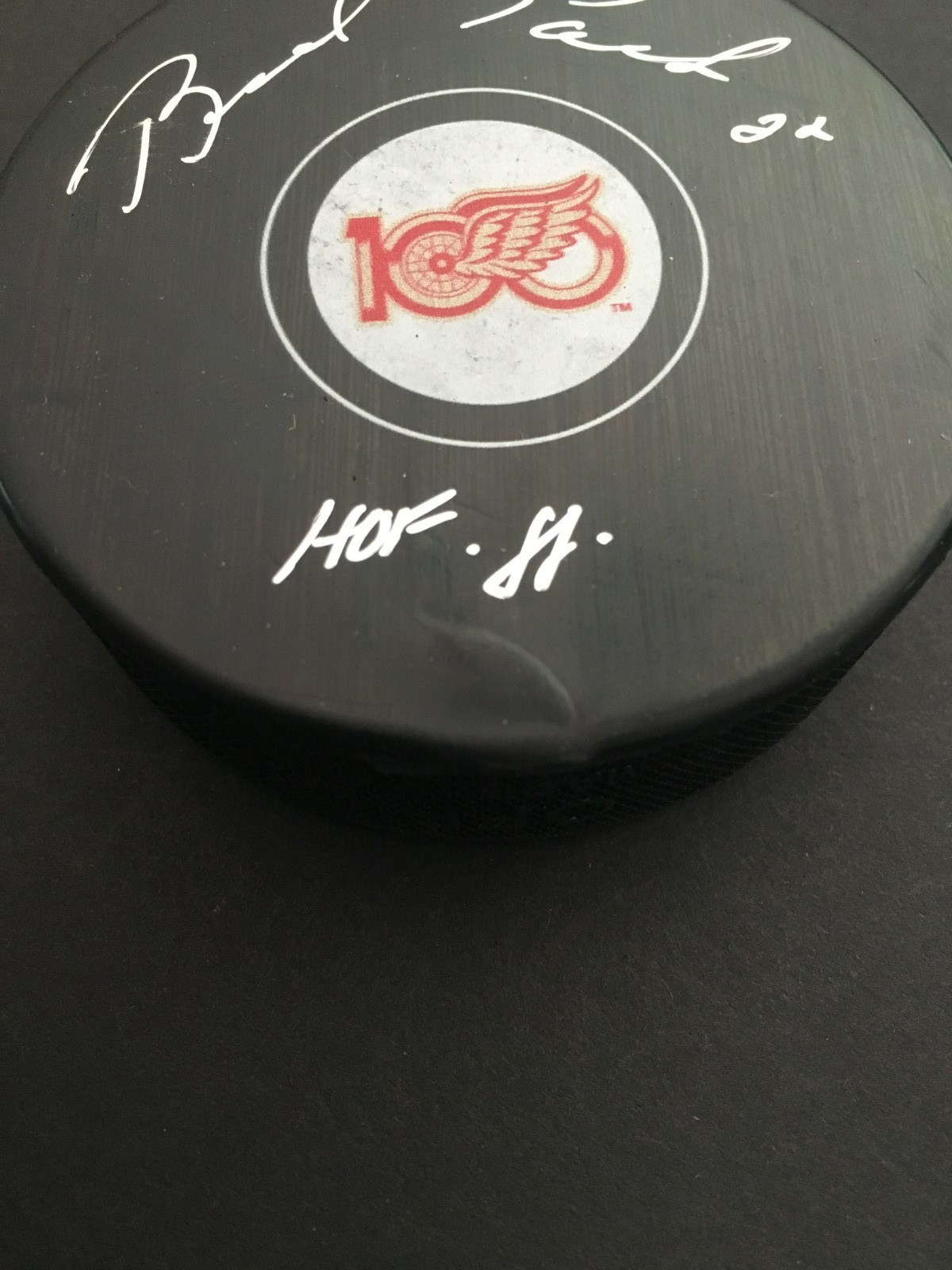 BRAD PARK AUTO’D RED WINGS “100” YEARS CENTENNIAL PUCK W/INSCR. JSA