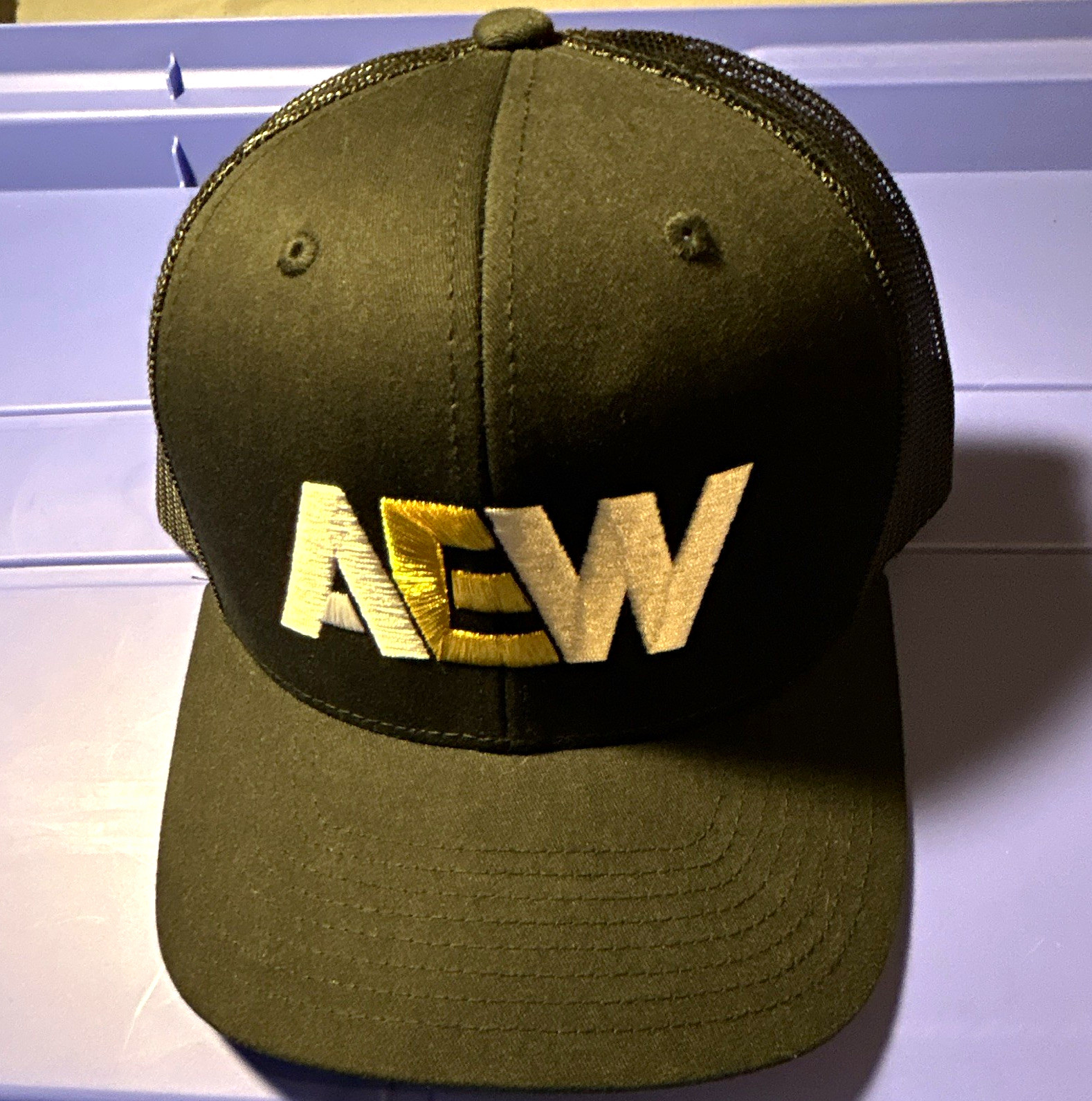 The Classics AEW Black Mesh Trucker Hat Embroidered Logo
